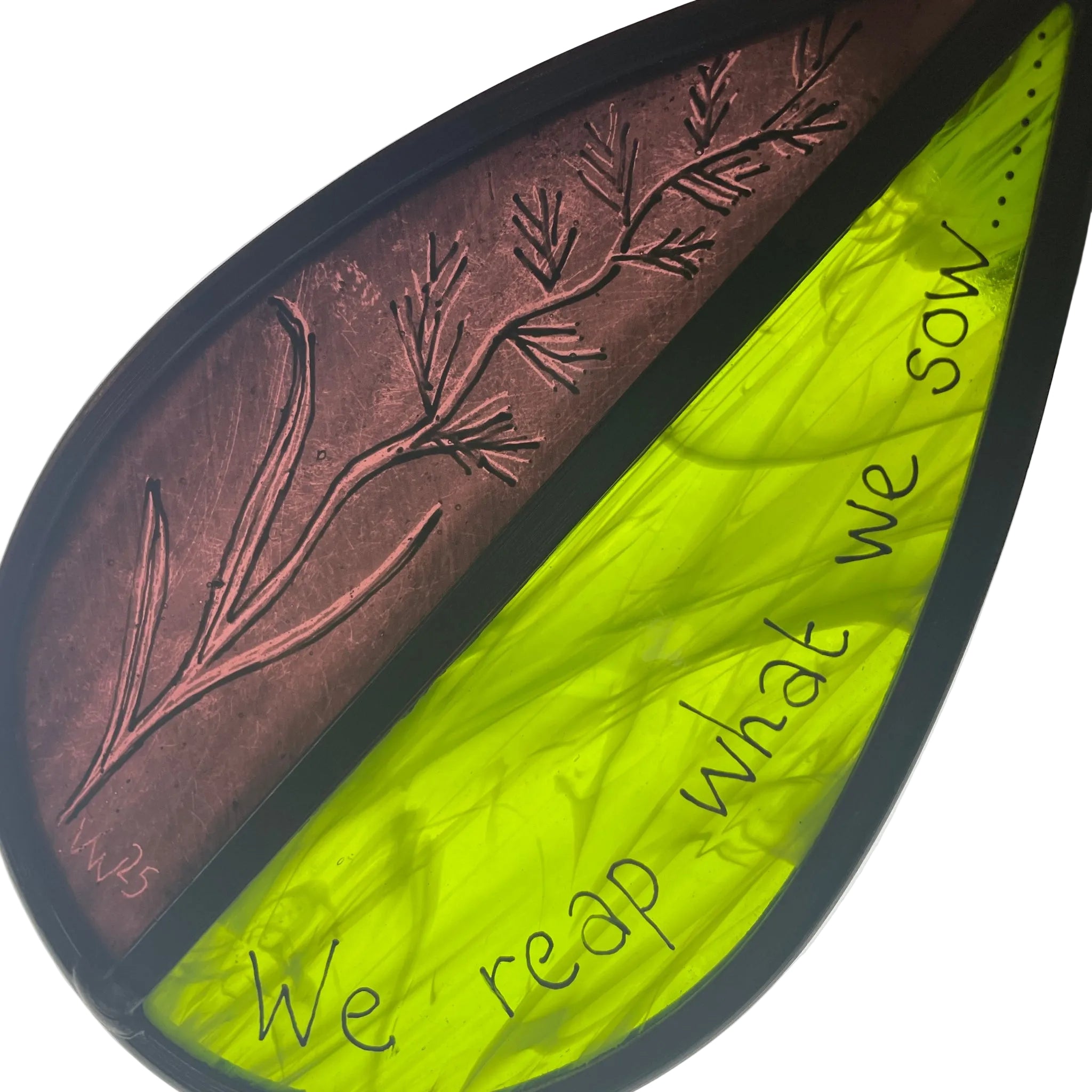 hand painted stained glass garden tree spinner, sun catcher, with text 'We reap what we sow' on a white background, purple and green glass, drawing of wheat flower,
