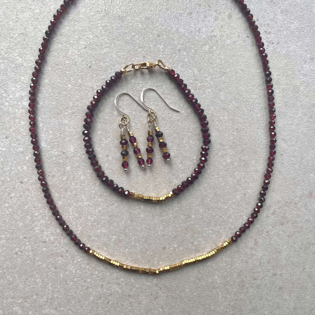 garnet and hematite necklace, bracelet and earrings set, with quality 14k rolled gold fixings and sterling silver ear hooks,  on cream background