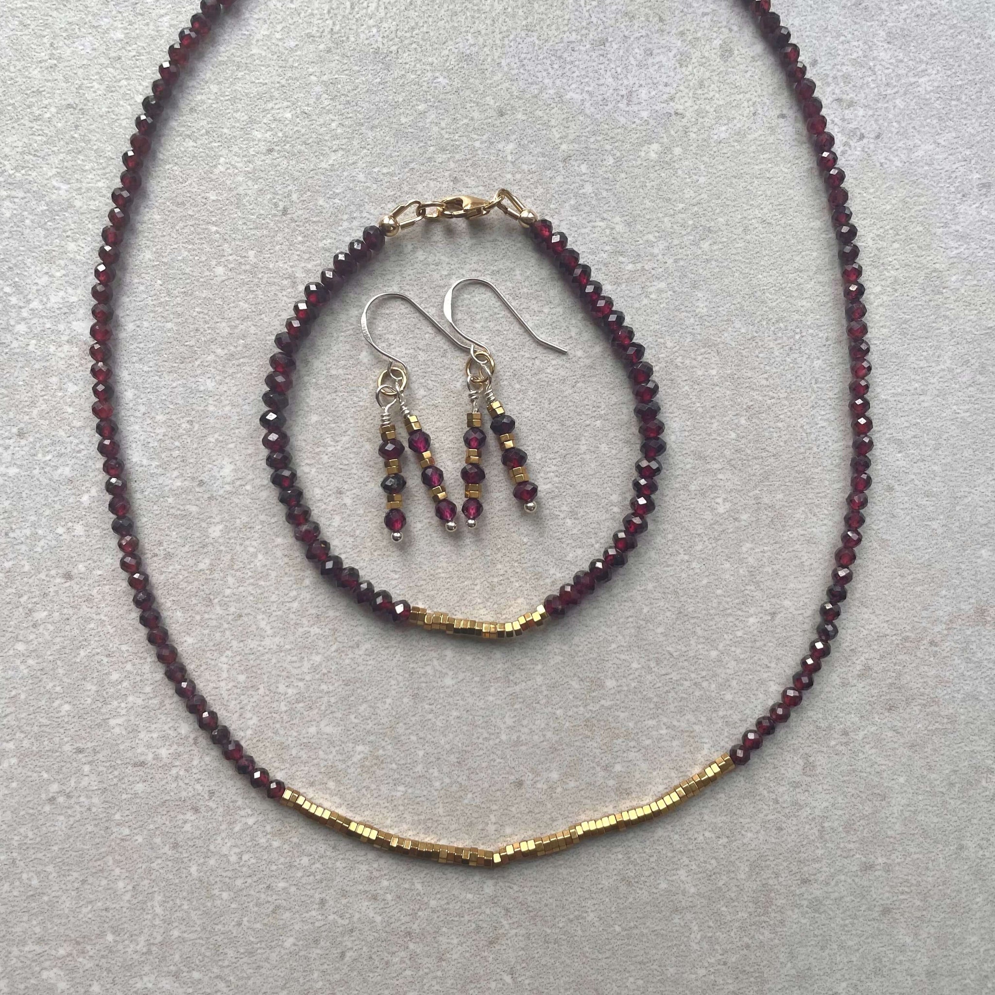 garnet and hematite necklace, bracelet and earrings set, with quality 14k rolled gold fixings and sterling silver ear hooks,  on cream background