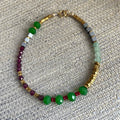 Beaded bracelet with green, red, and gold beads on a textured surface, green, pink, glass beads,  red garnet, golden hematite beads on 14k rolled gold  findings, 