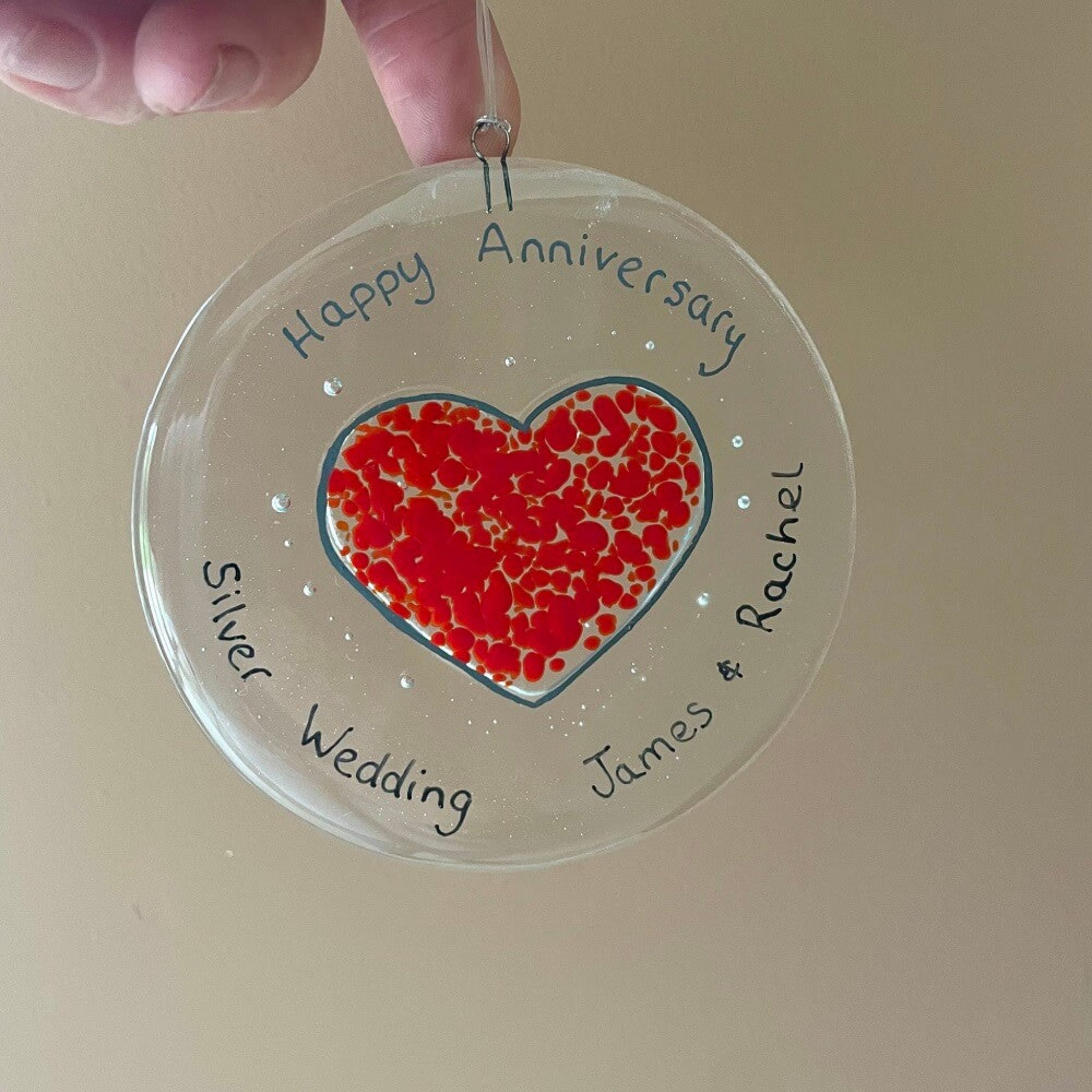 personalised hand painted fused glass clear glass circle, with heart shape, hanging decoration / sun catcher, special birthdays, celebrations, with personalised happy anniversary message.