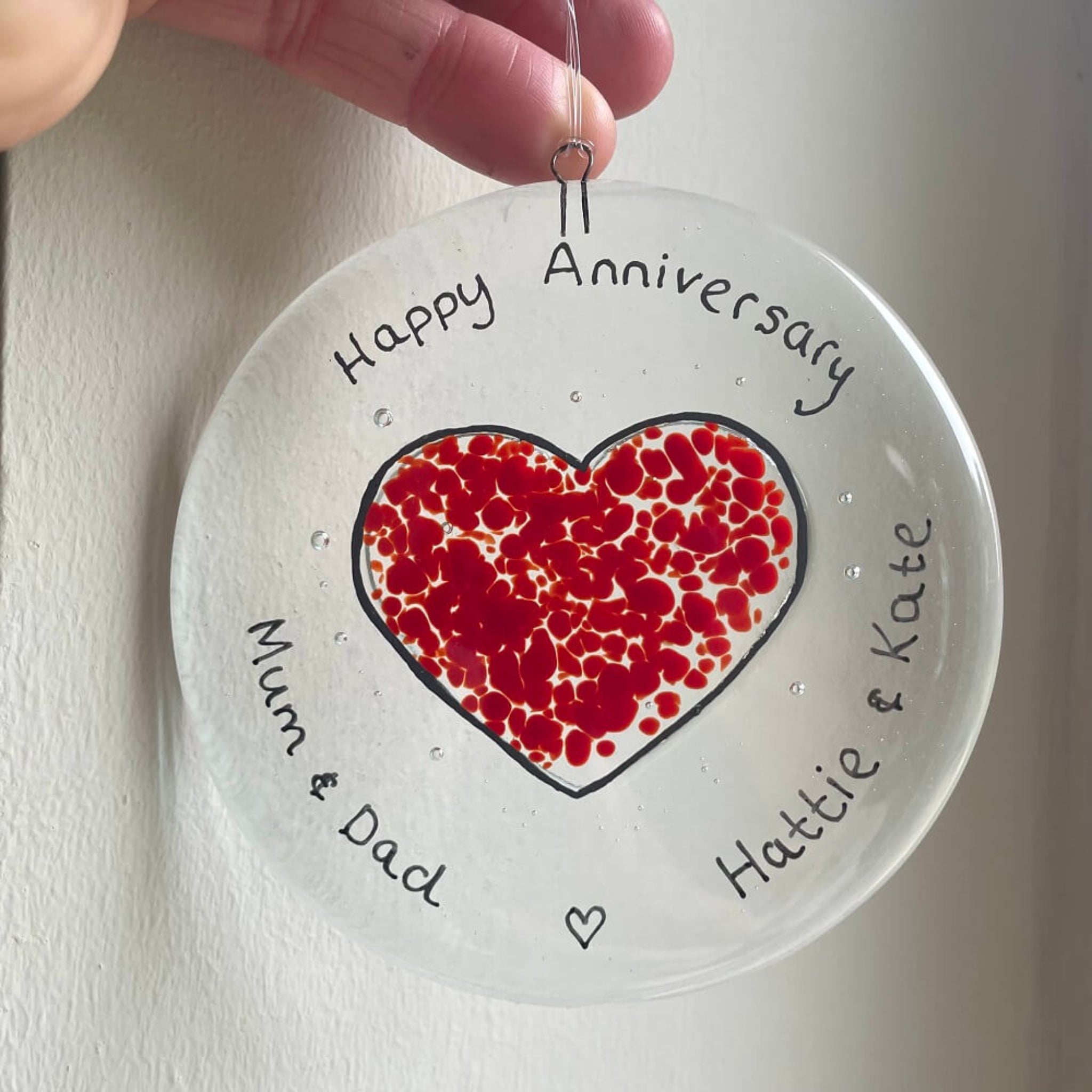 personalised hand painted fused glass clear glass circle, with heart shape, hanging decoration / sun catcher, special birthdays, celebrations, with personalised happy anniversary message.