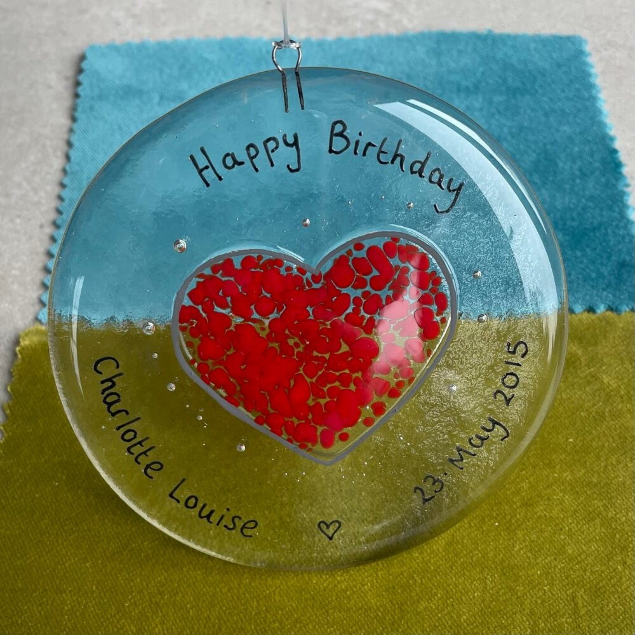 personalised hand painted fused glass clear glass circle, with heart shape, hanging decoration / sun catcher, special birthdays, celebrations, with personalised happy anniversary message.