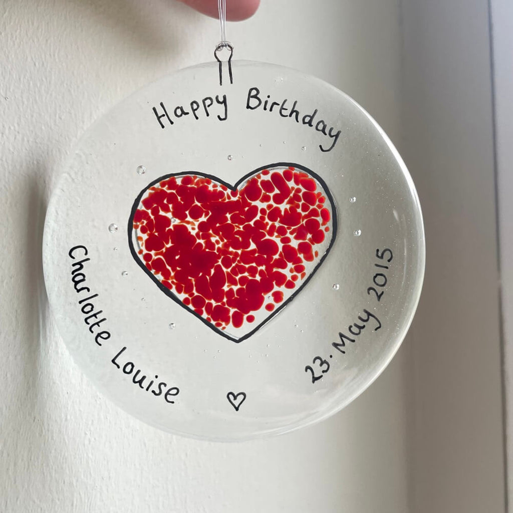 personalised hand painted fused glass clear glass circle, with heart shape, hanging decoration / sun catcher, special birthdays, celebrations, with personalised happy anniversary message.
