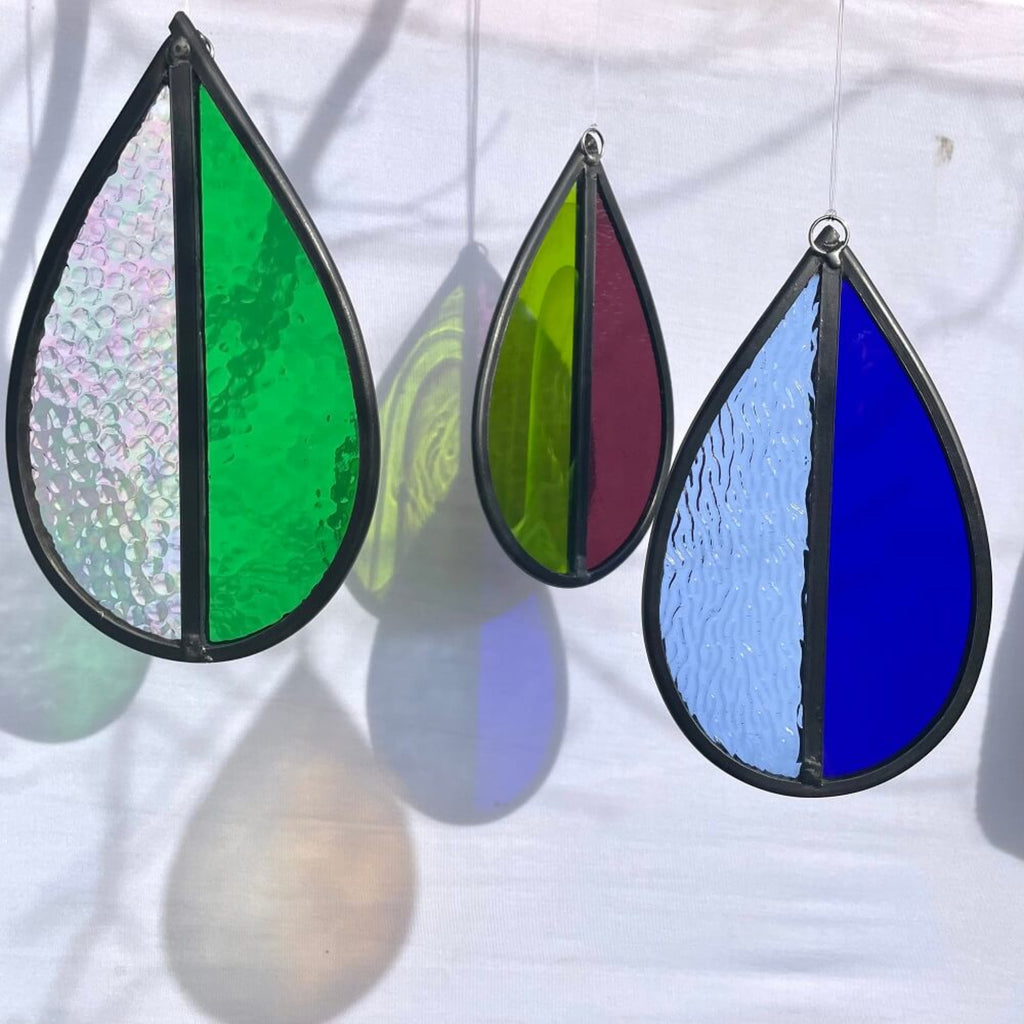 Set of 3  stained glass,  dark blue and light blue hanging stained glass, garden tree spinner or window sun catcher, green and purple coloured glass, hanging against a white background