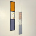  hanging stained glass panels, sun catcher with orange and purple glass, on a plain background, orange and purple glass stained glass garden tree spinner / in house sun catcher, 3 glass sections, rectangle stained glass panel.